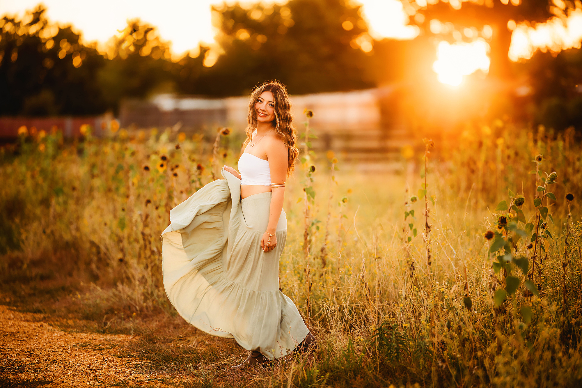 Outdoor senior photos in the flowers at golden hour