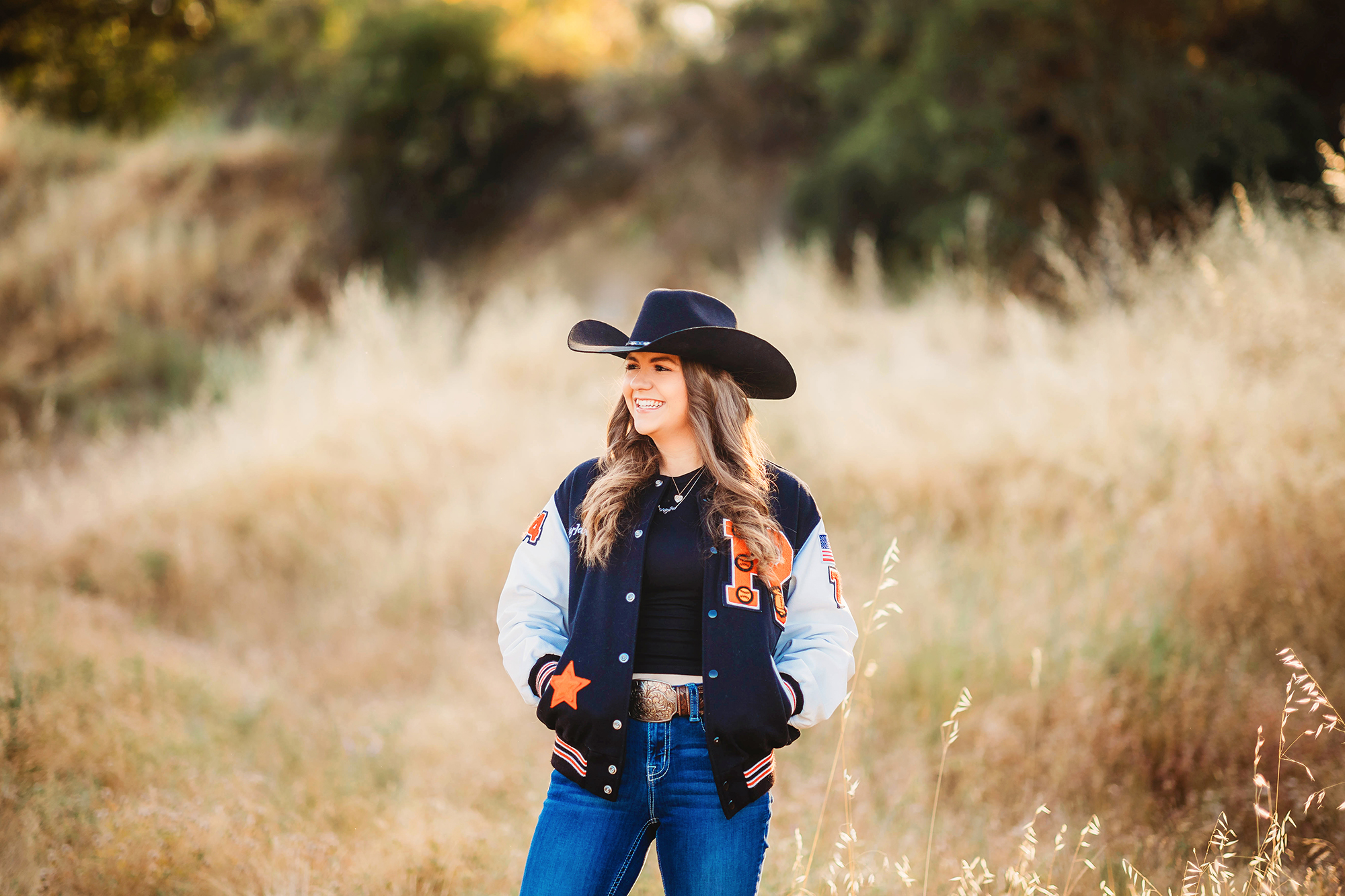 Outdoor senior photos with lettermans jacket